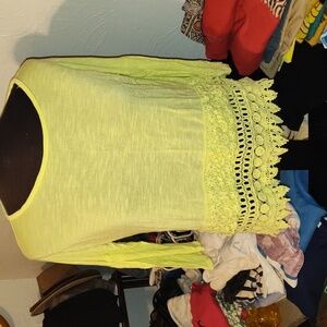 Signature studio, yellow top,with knitted lace along the front bottom of shirt.